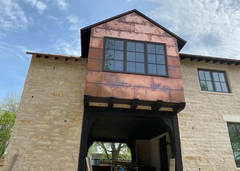 Copper metal panel facade on a stone building for Skylight Installation in Boulder Creek